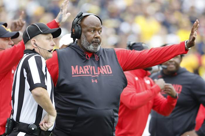 Maryland Terrapins head coach Mike Locksley talks to the referee in the second half against the Michigan Wolverines at Michigan Stadium.