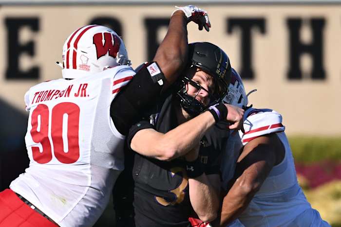 Wisconsin defensive ends James Thompson Jr. and Rodas Johnson hit the Northwestern quarterback.
