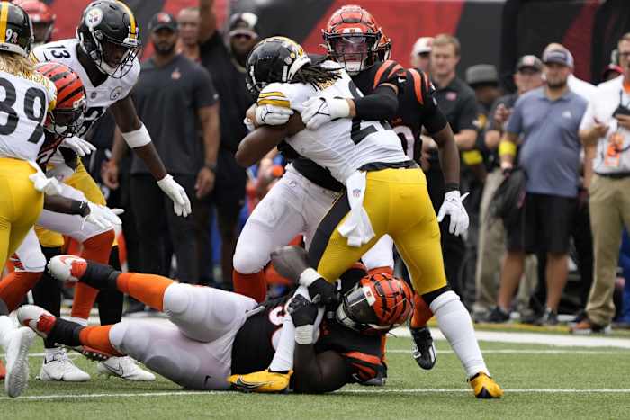 Sep 11, 2022; Cincinnati Bengals linebacker Logan Wilson (55) and defensive tackle DJ Reader (98) tackle Pittsburgh Steelers running back Najee Harris (22) for a loss. Mandatory Credit: Cara Owsley-USA TODAY