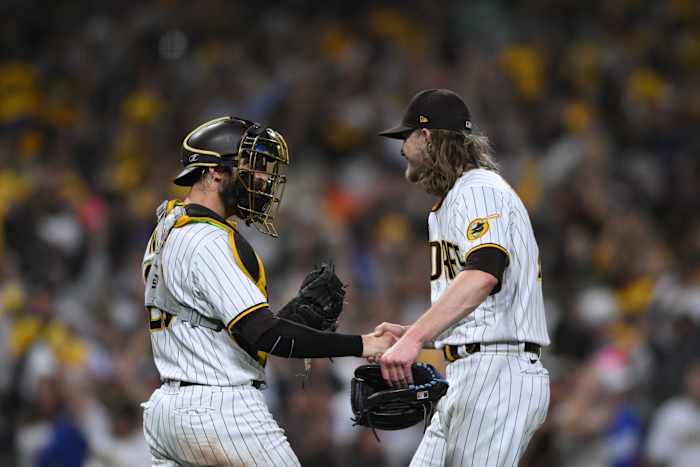 San Diego Padres catcher Austin Nola (26) and relief pitcher Josh Hader (71) celebrate defeating the Los Angeles Dodgers during game three of the NLDS for the 2022 MLB Playoffs at Petco Park.