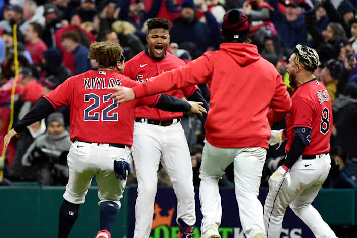 Oscar González celebrates with his teammates after walking off the Yankees.