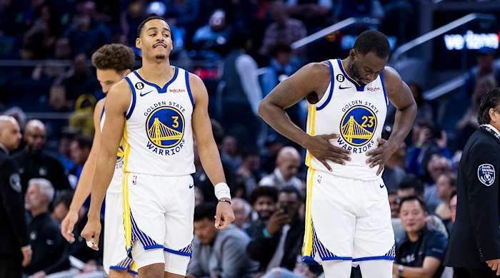 Warriors guard Jordan Poole (3) and forward Draymond Green (23) re-enter the court after a time-out during the first half of the game against the Nuggets at Chase Center.