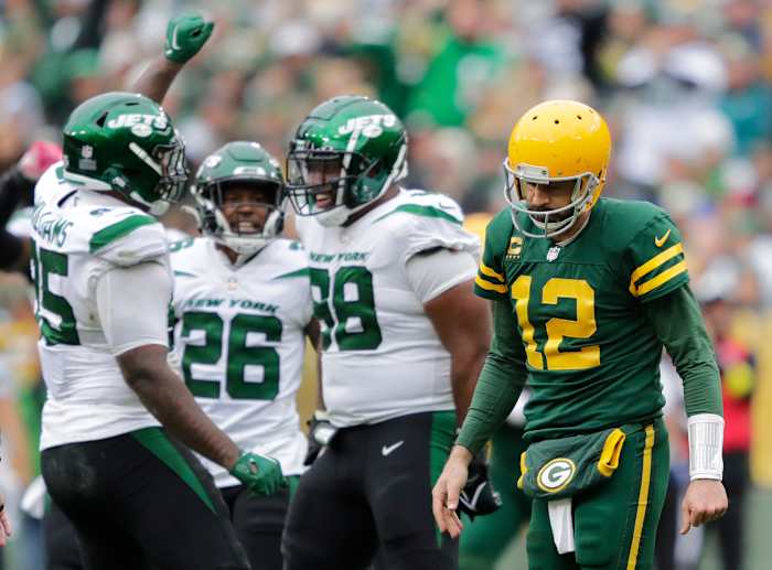 Green Bay Packers quarterback Aaron Rodgers (12) walks off the field after getting sacked by New York Jets defensive tackle Quinnen Williams (95) in the third quarter at Lambeau Field.