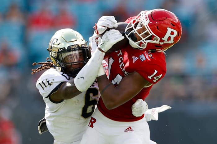 #6 Ja'Sir Taylor tries to knock the ball loose from the Rutgers receiver in the 2021 Gator Bowl
