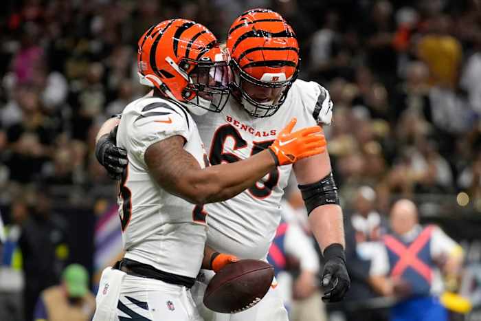 Cincinnati Bengals guard Alex Cappa (65) congratulates Cincinnati Bengals running back Joe Mixon (28) after a touchdown in the first quarter during an NFL Week 6 game against the New Orleans Saints, Wednesday, Oct. 6, 2021, at Mercedes-Benz Superdome in New Orleans. Cincinnati Bengals At New Orleans Saints Oct 16 010