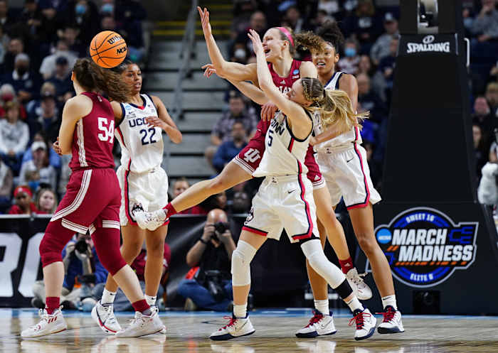 Grace Berger and Mackenzie Holmes defend the ball against UConn.