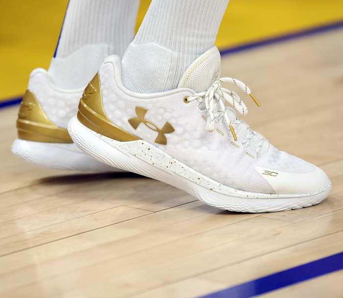 White and Gold Curry 1 shoes.
