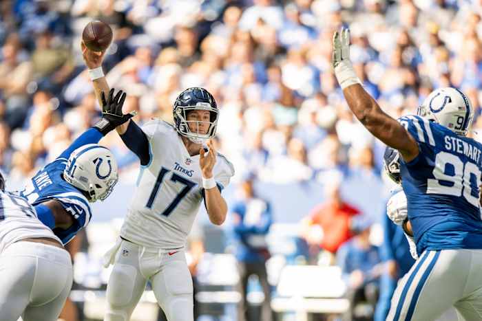 Oct 2, 2022; Indianapolis, Indiana, USA; Tennessee Titans quarterback Ryan Tannehill (17) throws a pass between Indianapolis Colts defensive end Kwity Paye (51) and Indianapolis Colts defensive tackle Grover Stewart (90) during the first quarter at Lucas Oil Stadium.
