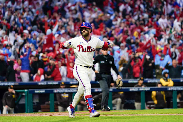Phillies slugger Bryce Harper rounds the bases after hitting a pennant-winning two-run homer.