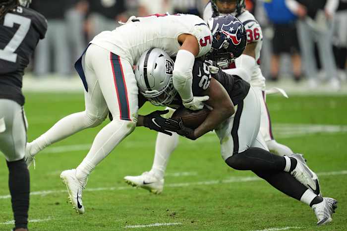 Oct 23, 2022; Paradise, Nevada, USA; Las Vegas Raiders running back Josh Jacobs (28) runs into Houston Texans safety Jalen Pitre (5) in the first half at Allegiant Stadium. Mandatory Credit: Stephen R. Sylvanie-USA TODAY Sports