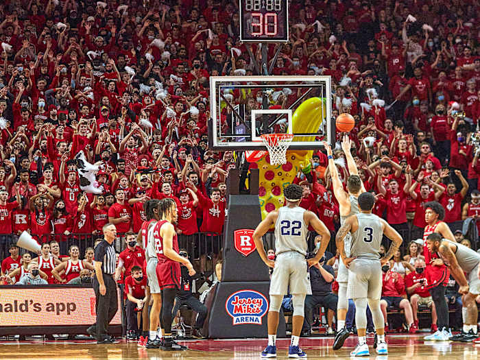 Rutgers students wave their arms during an opposing free throw