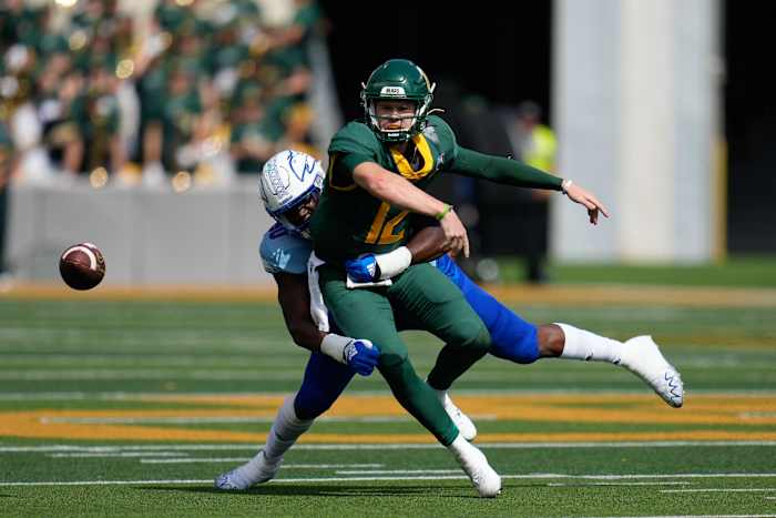 Oct 22, 2022; Waco, Texas, USA; Bears quarterback Blake Shapen (12) fumbles after being tackled by Kansas Jayhawks defensive lineman Jereme Robinson (90) during the second half at McLane Stadium. Mandatory Credit: Chris Jones-USA TODAY Sports