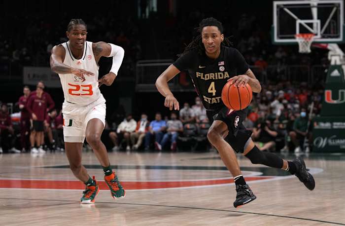 #4 Caleb Mills drives by #23 Kam McGusty of Miami. Mills is a dark horse pick for ACC Player of the Year