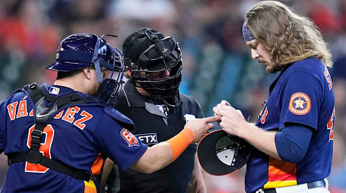 Astros pitcher Ryne Stanek tries to adjust his PitchCom device.