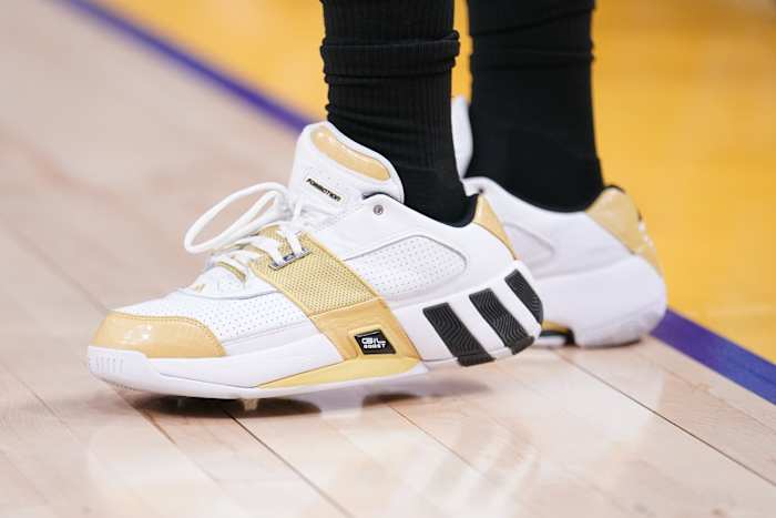 White, gold, and black Adidas shoes.