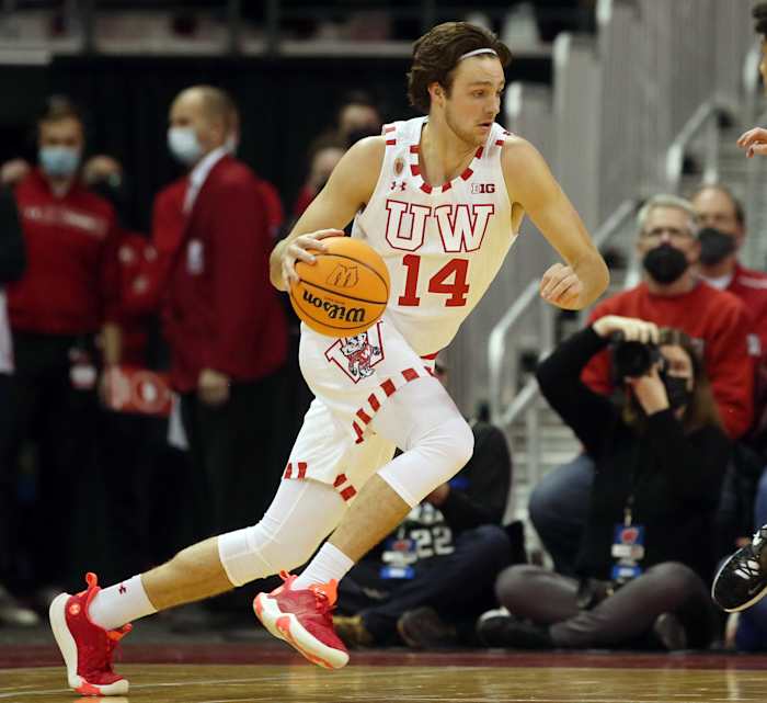 Wisconsin forward Carter Gilmore dribbling the basketball during a game.