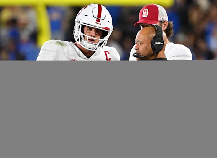 Stanford Cardinal head coach David Shaw talks with quarterback Tanner McKee (18) during a time out in the first half against the UCLA Bruins at the Rose Bowl.