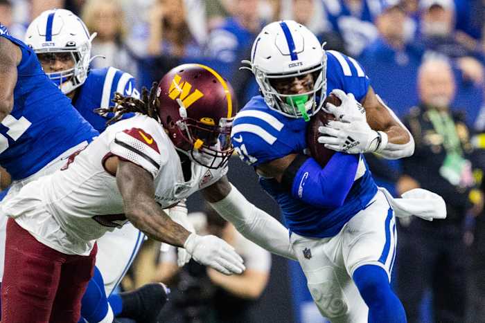 Oct 30, 2022; Indianapolis, Indiana, USA; Indianapolis Colts running back Nyheim Hines (21) runs the ball while Washington Commanders safety Bobby McCain (20) defends in the second quarter at Lucas Oil Stadium. Mandatory Credit: Trevor Ruszkowski-USA TODAY Sports