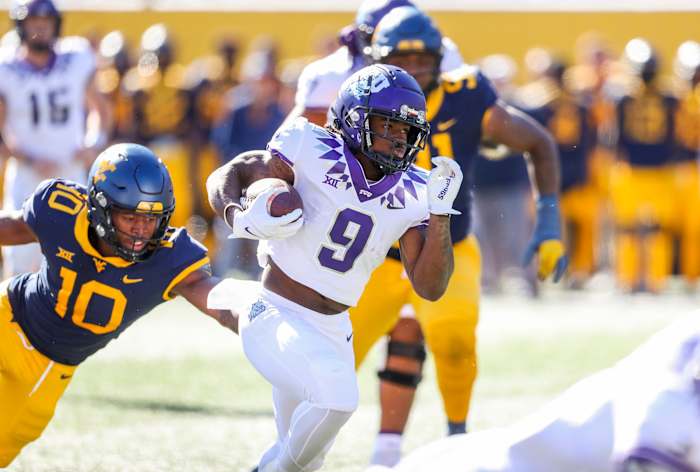 Oct 29, 2022; Morgantown, West Virginia, USA; TCU Horned Frogs running back Emani Bailey (9) runs the ball for a touchdown during the second quarter against the West Virginia Mountaineers at Mountaineer Field at Milan Puskar Stadium. Mandatory Credit: Ben Queen-USA TODAY Sports