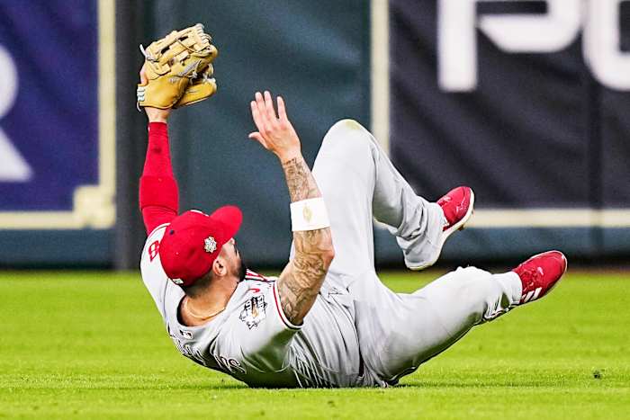 Phillies right fielder Nick Castellanos holds up his arms after making a game-saving sliding catch in Game 1 of the World Series vs. the Astros.