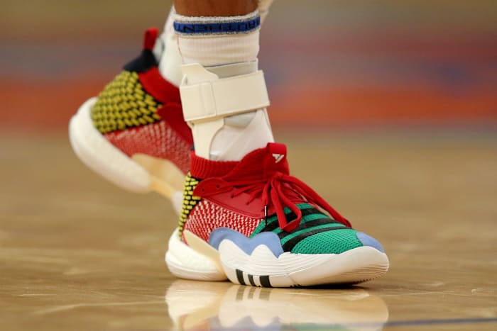 View of Trae Young's multi-color Adidas shoes.