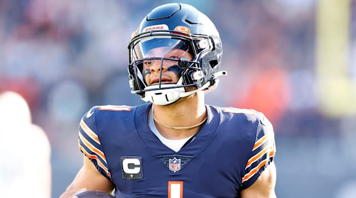 Bears quarterback Justin Fields (1) rushes the ball for a touchdown during a game against the Dolphins.