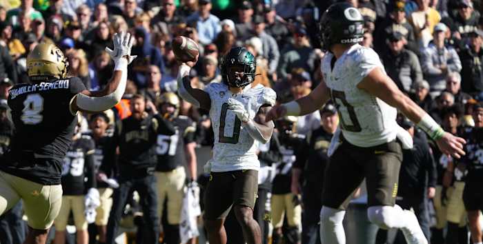 Running back Bucky Irving throws a touchdown to Bo Nix against Colorado.