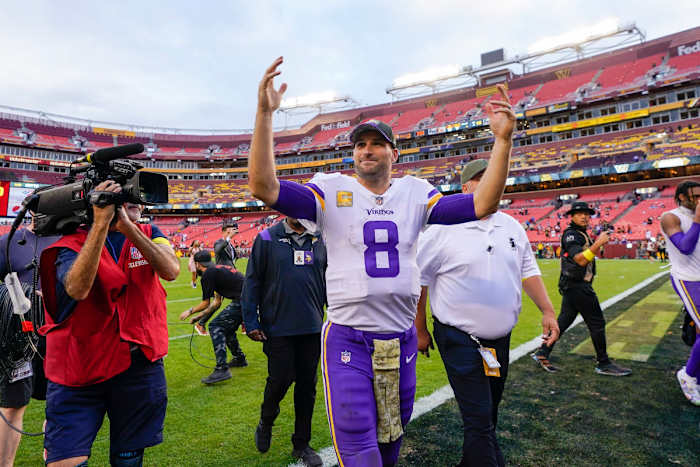 Kirk Cousins smiles and waves to the crowd as he leaves FedEx Field