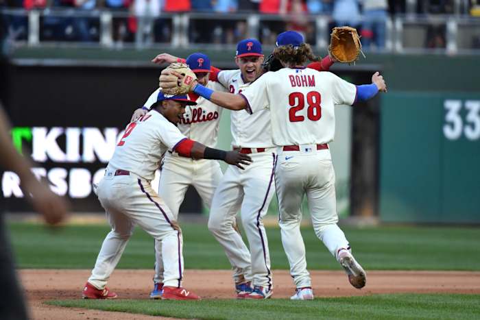 Jean Segura, Bryson Stott, Rhys Hoskins, and Alec Bohm (28) celebrate a series-clinching victory over the Atlanta Braves in Game 4 of the NLDS.