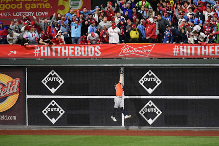 Astros player Chas McCormick jumps to make a catch