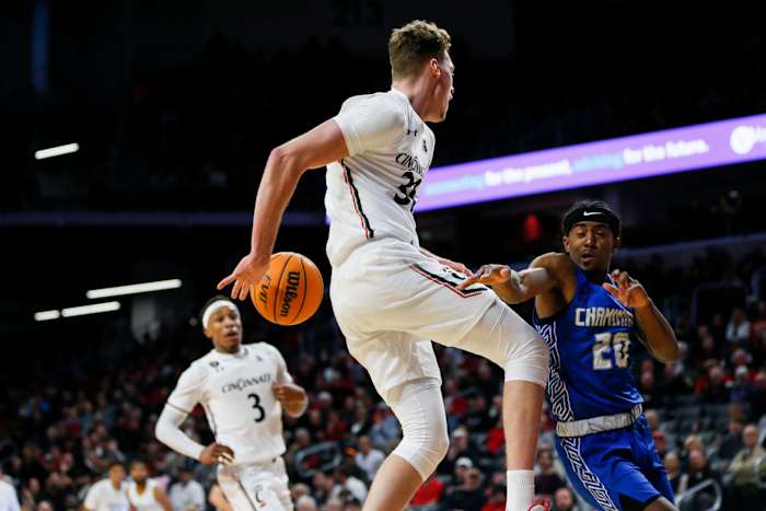 Cincinnati Bearcats forward Viktor Lakhin (30) passes the ball to Cincinnati Bearcats guard Mika Adams-Woods (3) during the first half of the basketball game between the Cincinnati Bearcats and the Chaminade Silverswords on Monday, Nov. 7, 2022, at Fifth Third Arena in Cincinnati. The Cincinnati Bearcats defeated the Chaminade Silverswords 98-55. Cincinnati Bearcats Men S Basketball Versus Chaminade Silverswords