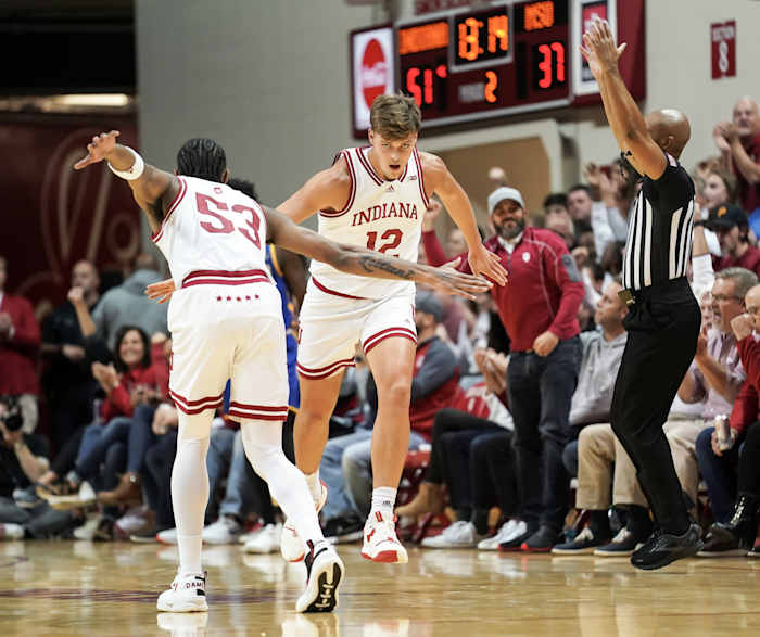 Indiana Hoosiers forward Miller Kopp (12) high-fives Indiana Hoosiers guard Tamar Bates (53) after making a three-pointer during the second half at Simon Skjodt Assembly Hall.