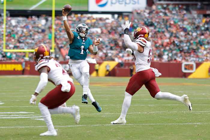 Washington Commanders defend a pass from Philadelphia Eagles quarterback, Jalen Hurts (1).