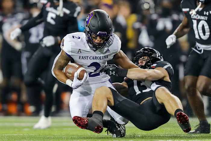 Nov 11, 2022; Cincinnati, Ohio, USA; Cincinnati Bearcats linebacker Ty Van Fossen (13) brings down East Carolina Pirates running back Keaton Mitchell (2) in the first half at Nippert Stadium. Mandatory Credit: Katie Stratman-USA TODAY Sports