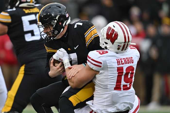 Wisconsin outside linebacker Nick Herbig sacks the Iowa quarterback.