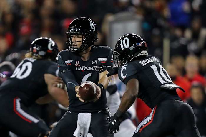 Nov 11, 2022; Cincinnati, Ohio, USA; Cincinnati Bearcats quarterback Ben Bryant (6) hands the ball off to running back Charles McClelland (10) in the first half against the East Carolina Pirates at Nippert Stadium. Mandatory Credit: Katie Stratman-USA TODAY Sports
