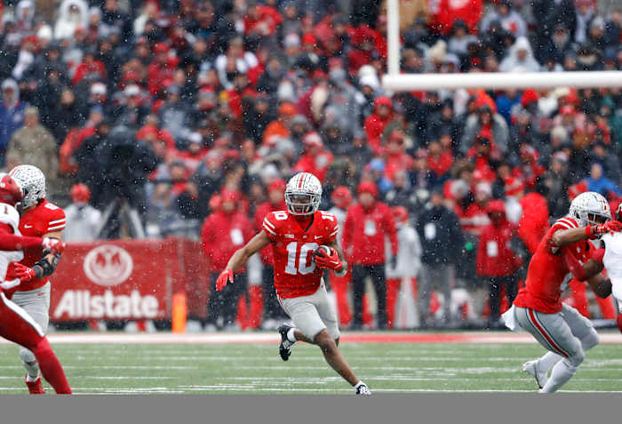 Xavier Johnson catches a screen pass and looks for a running lane.