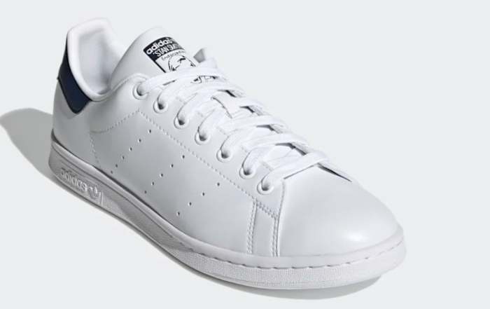 White and navy Adidas shoe.