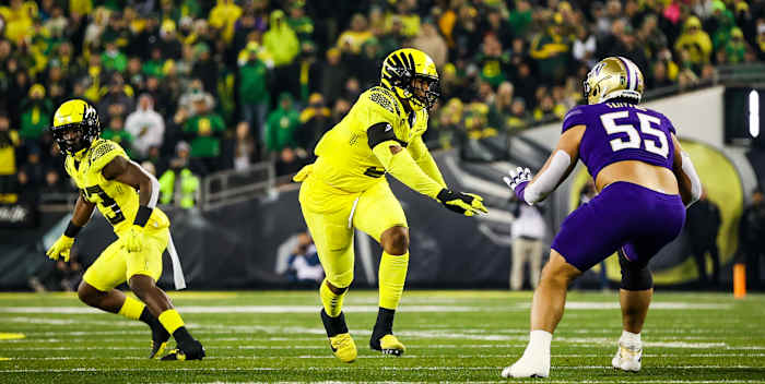 Oregon Ducks defensive lineman Brandon Dorlus rushes the passer against the Washington Huskies.