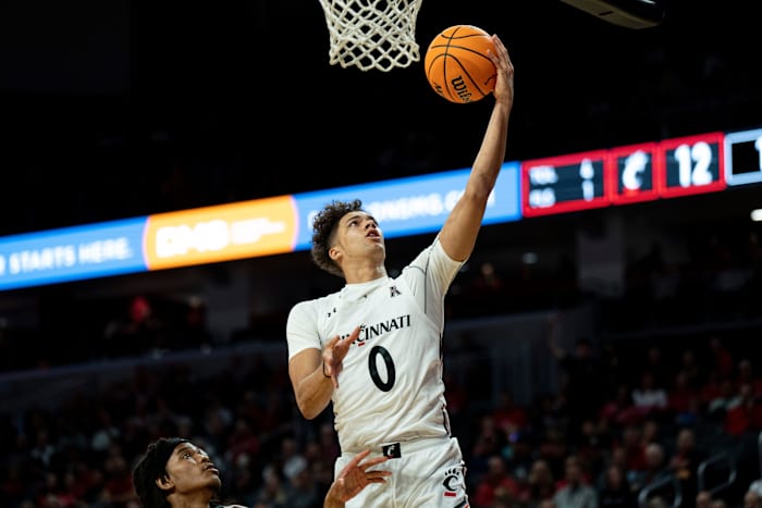 Cincinnati Bearcats guard Daniel Skillings (0) lays the ball up as Cleveland State Vikings guard JaMir Price (5) looks on in the first half of the men s NCAA basketball game between the Cincinnati Bearcats and the Cleveland State Vikings at Fifth Third Arena in Cincinnati on Thursday, Nov. 10, 2022. Cleveland State Vikings At Cincinnati Bearcats