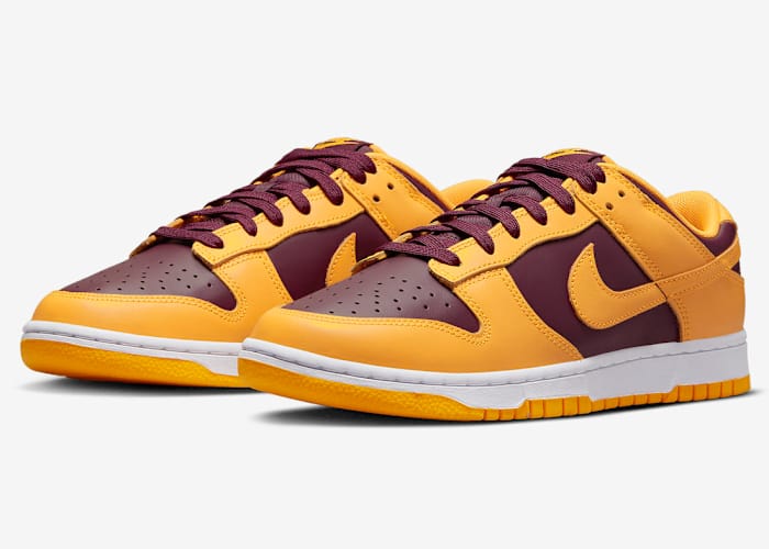 Maroon and gold Nike Dunk shoes.