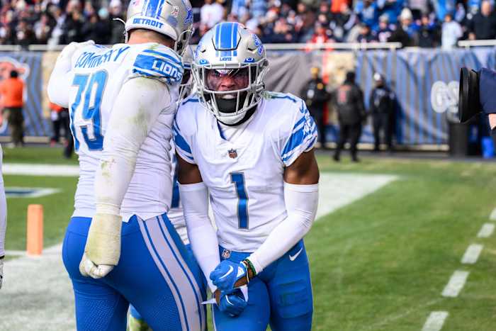 Two Lions players celebrate next to the endzone