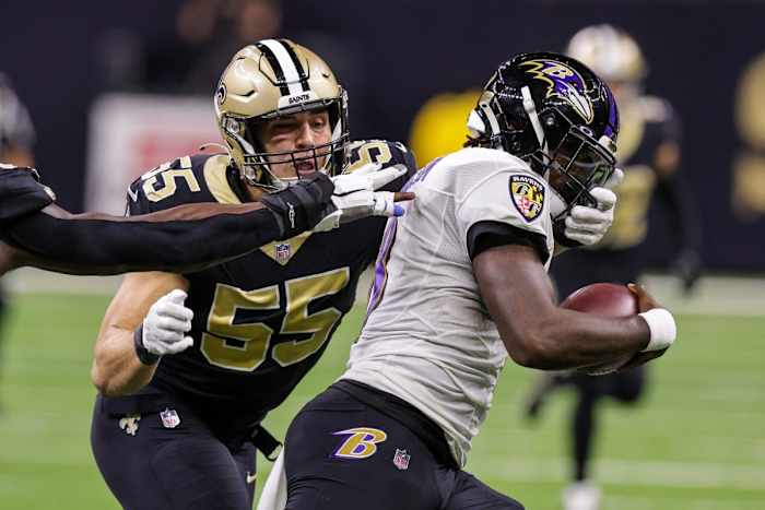 New Orleans Saints linebacker Kaden Elliss (55) tackles Baltimore Ravens quarterback Lamar Jackson (8) as he scrambles. Mandatory Credit: Stephen Lew-USA TODAY Sports
