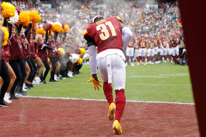 Washington Commanders safety Kamren Curl takes the field before a game.