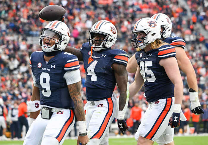 Tyler Fromm (85),Robby Ashford (9),and Tank Bigsby (4) celebrate a touchdownduring the football game between the Western Kentucky Hilltoppers and the Auburn Tigers at Jordan Hare Stadium in Auburn, AL on Saturday, Nov 19, 2022. Todd Van Emst/Auburn Tigers