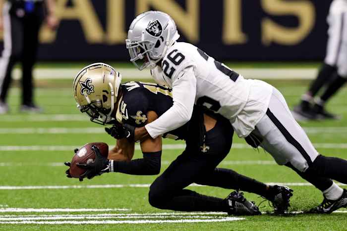 New Orleans Saints receiver Chris Olave (12) makes a catch against Raiders cornerback Rock Ya-Sin (26). Mandatory Credit: Stephen Lew-USA TODAY Sports