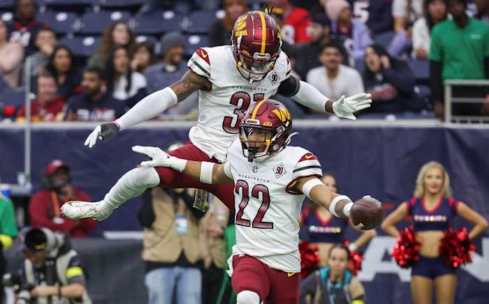 Washington Commanders safeties Darrick Forrest (22) and Kamren Curl (31) celebrate after a turnover against the Houston Texans.