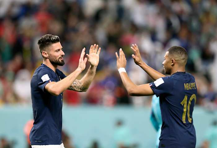 Olivier Giroud (left) and Kylian Mbappe pictured high-fiving during France's 4-1 win over Australia at the 2022 World Cup
