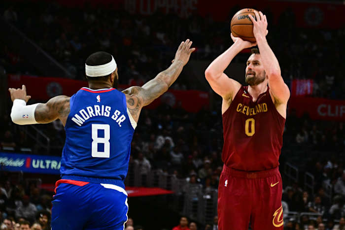 Nov 7, 2022; Los Angeles, California, USA; Cleveland Cavaliers forward Kevin Love (0) attempts a shot as Los Angeles Clippers forward Marcus Morris Sr. (8) defends in the fourth quarter at Crypto.com Arena. Mandatory Credit: Richard Mackson-USA TODAY Sports