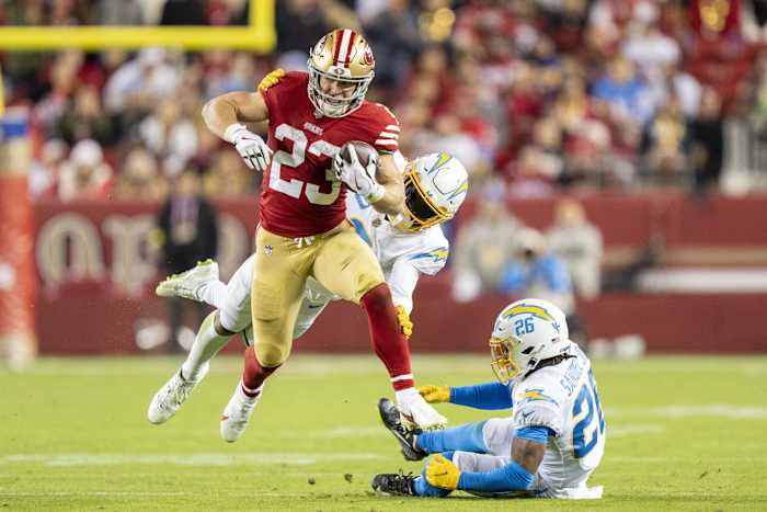 San Francisco 49ers running back Christian McCaffrey (23) runs past Los Angeles Chargers safety Derwin James Jr. (3) and cornerback Asante Samuel Jr. (26). Mandatory Credit: Kyle Terada-USA TODAY